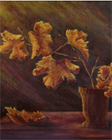 Vaso con foglie secche su un tavolo di legno